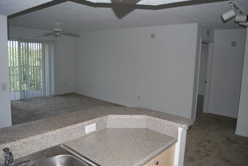 Portofino Apartments kitchen over looking living area at Portofino, Palm Springs, FL