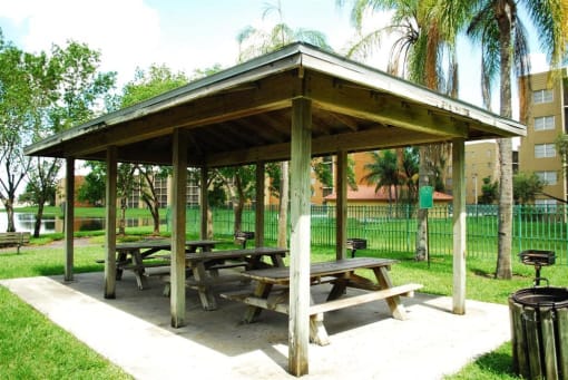 Covered seating near grass Heron Pointe Apartments Miramar Florida