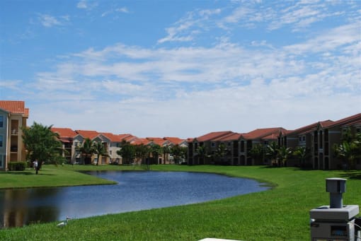 Renaissance community exterior with palm trees and lake views
