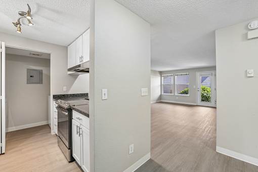 A kitchen with a stove top oven and a refrigerator.