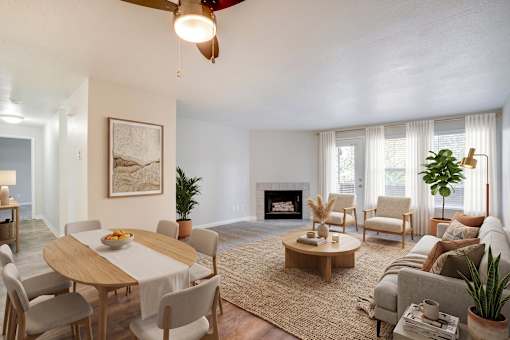 A living room with a fireplace, a dining table, and a couch.