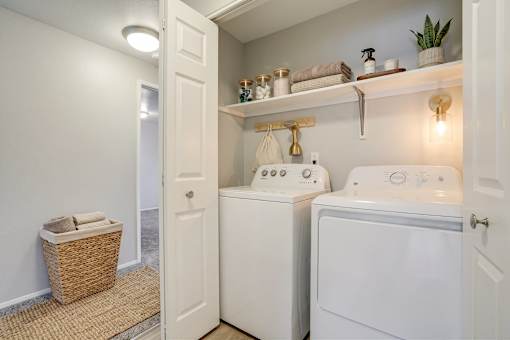 A small laundry room with a washer and dryer.
