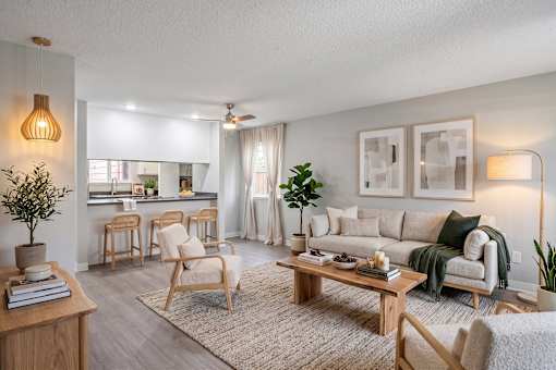 A living room with a sofa, chairs, and a coffee table.