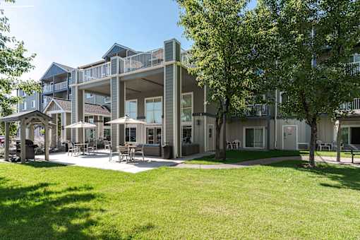 A large building with a green lawn in front.