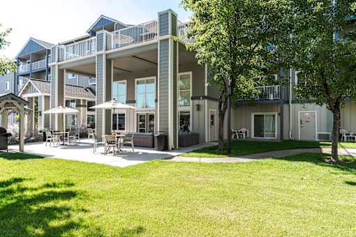 A large building with a green lawn in front.
