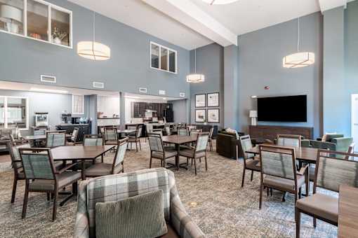 A large room with a variety of chairs and tables.