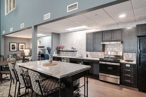A modern kitchen with a large island and stainless steel appliances.