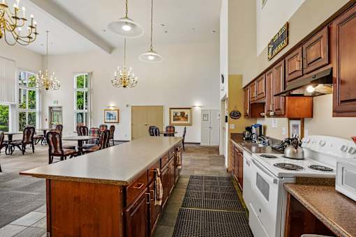 A kitchen with a white stove top oven and a white microwave at Vintage at Burien, Burien, WA
