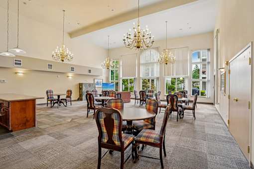 A large room with a dining table and chairs at Vintage at Burien, Burien, Washington