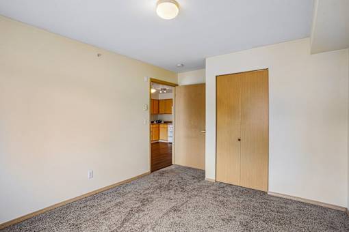 A room with a carpeted floor and a doorway leading to another room at Vintage at Burien,Burien,98168