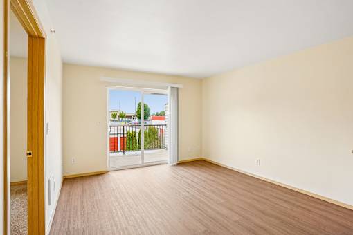 A room with a sliding glass door leading to a balcony at Vintage at Burien,Burien,WA