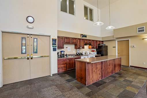A kitchen with a brown counter and a clock on the wall at Vintage at Burien,Burien,WA,98168