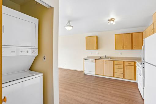A kitchen with white appliances and wooden cabinets at Vintage at Burien,Burien,WA,98168