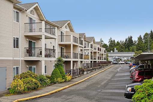 A row of apartment buildings with a parking lot in front at Vintage at Burien, Burien ,Washington