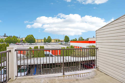 A view from a balcony looking at a building with a red roof at Vintage at Burien, Burien, WA