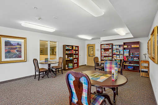 A room with a table and chairs and a bookshelf at Vintage at Burien,Burien,WA,98168