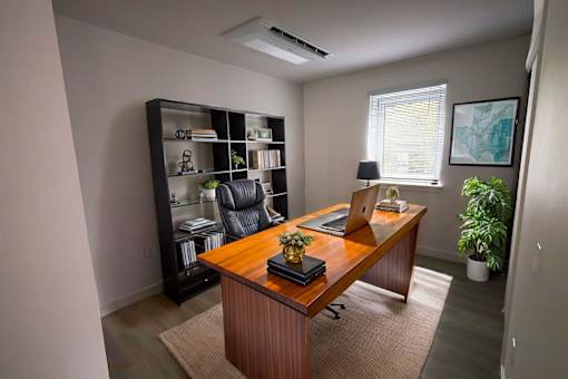 A room with a desk, chair, and bookshelf.