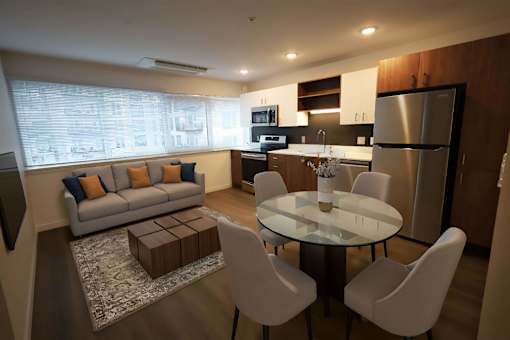 A modern kitchen with a dining table and chairs.