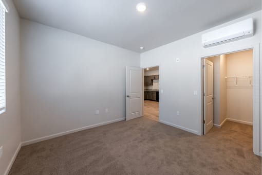a bedroom with a closet and a door to a bathroom at Springview by Vintage, Reno, 89512