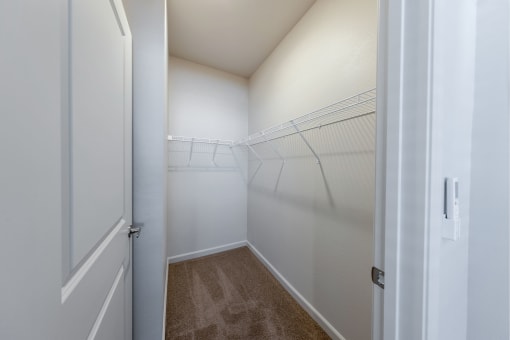 a spacious closet in a bedroom with white walls and a white door at Springview by Vintage, Reno, NV, 89512