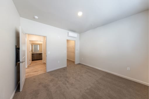 a living room with white walls and a door to a bathroom at Springview by Vintage, Reno, NV, 89512