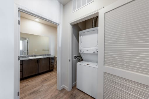 a laundry room with a washer and dryer inside of a door at Springview by Vintage, Nevada