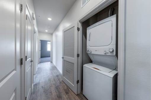 a laundry room with a washer and dryer and a door to a closet at Springview by Vintage, Reno, NV