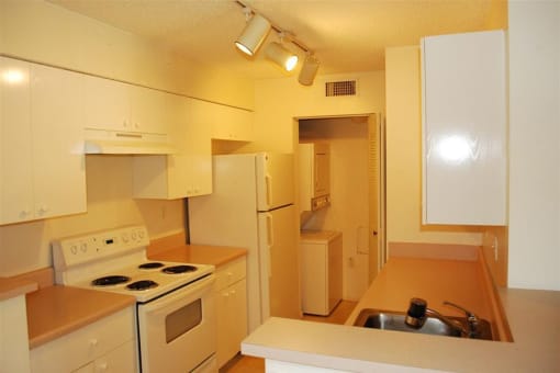 Marbrisa Apartments kitchen with white appliances and lots of cabinetry at Marbrisa Apartments, Florida