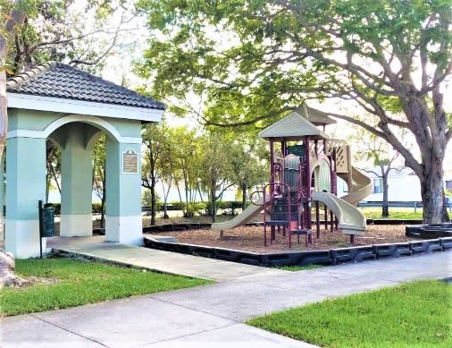 Mirabella Apartments community exterior with sidewalks and playground at Mirabella Apartments, Princeton, FL, 33032