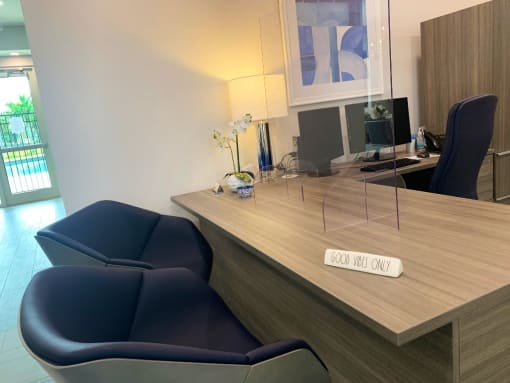 Tuscany Place leasing office with desk and chairs at Tuscany Place Apartments, Homestead 