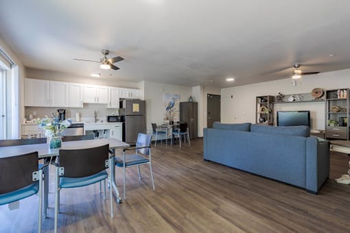 a living room with a couch and a table with chairs