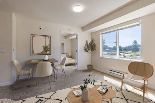 a living room with a table and chairs and a large window