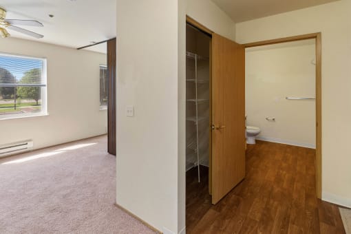 an empty room with a closet and a toilet in it