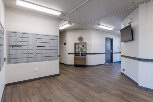 a hallway with lockers and a television on the wall