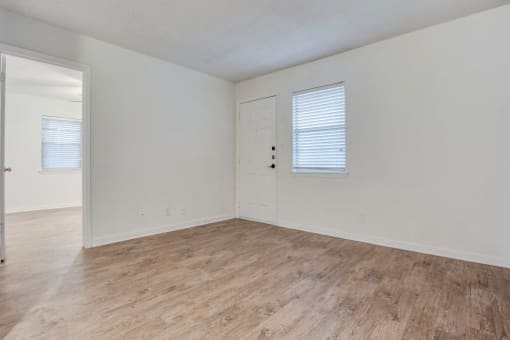 bedroom with hardwood floors and white walls at THE EASTWOOD, Texas