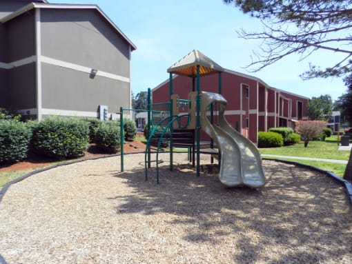a playground with a slide in front of a building at Fort Vancouver Terrace, Vancouver