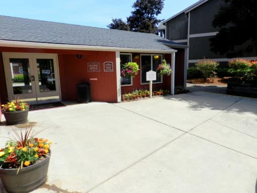 the front of a building with a sidewalk and potted plants at Fort Vancouver Terrace, Washington, 98661