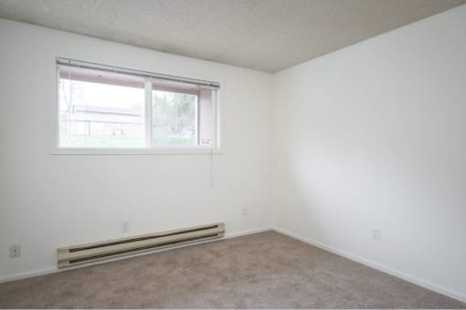 an empty room with a window and carpet at Fort Vancouver Terrace, Vancouver, WA, 98661