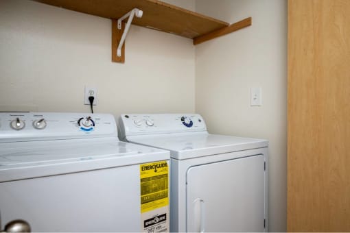 two washers and dryers in a room with a closet at Fort Vancouver Terrace, Vancouver