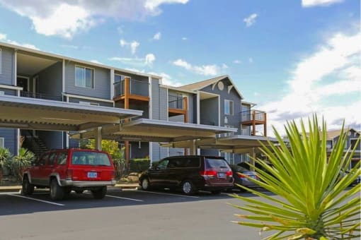 two cars parked in a parking lot in front of a building at Troutdale Terrace, Troutdale, OR