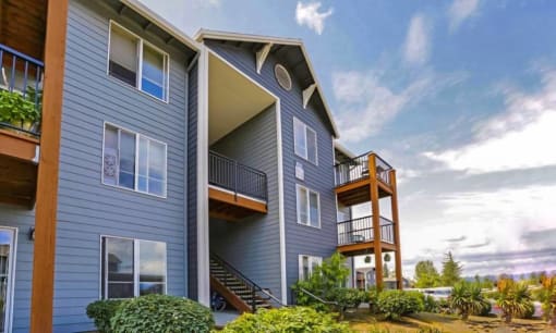 a blue house with a deck and a blue sky at Troutdale Terrace, Oregon