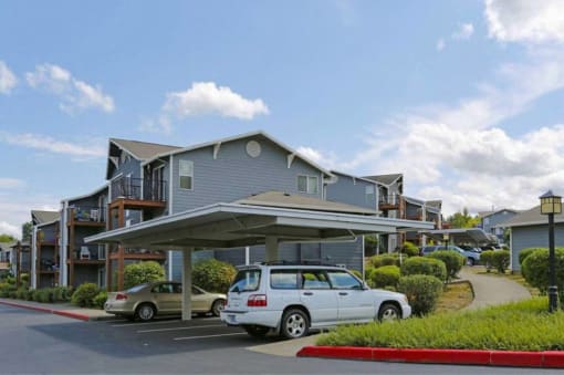 a parking lot with cars in front of a building at Troutdale Terrace, Oregon 97060