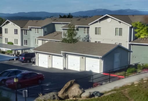 a row of houses with cars parked in a parking lot at Troutdale Terrace, Troutdale, Oregon