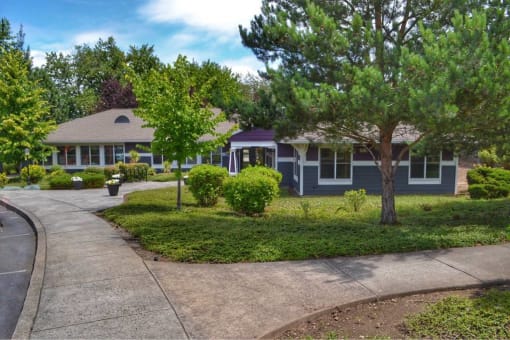 a house with a sidewalk and trees in front of it at Troutdale Terrace, Troutdale