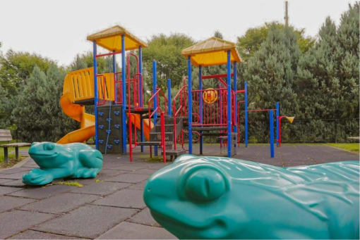 a children playground with two swings and a slide at Troutdale Terrace, Troutdale, OR