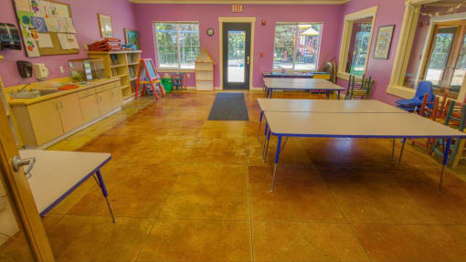a classroom with tables and chairs and a sink at Troutdale Terrace, Troutdale