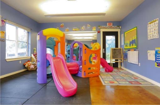 a children play room with slides and toys at Troutdale Terrace, Troutdale