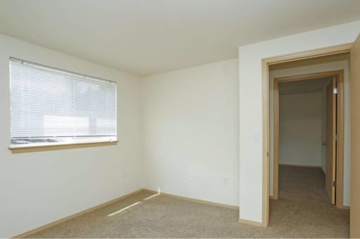 an empty room with a window and a door at Troutdale Terrace, Troutdale, OR