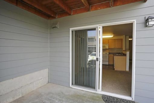 a sliding glass door in a room with a kitchen at Troutdale Terrace, Troutdale