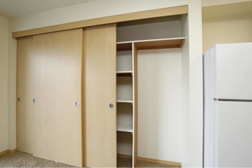 a wardrobe with shelves and a refrigerator in a room at Troutdale Terrace, Oregon 97060